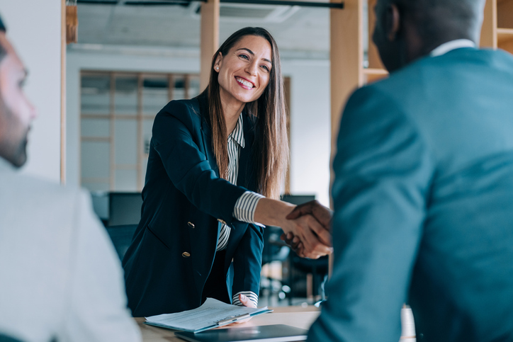 people shaking hands at a meeting